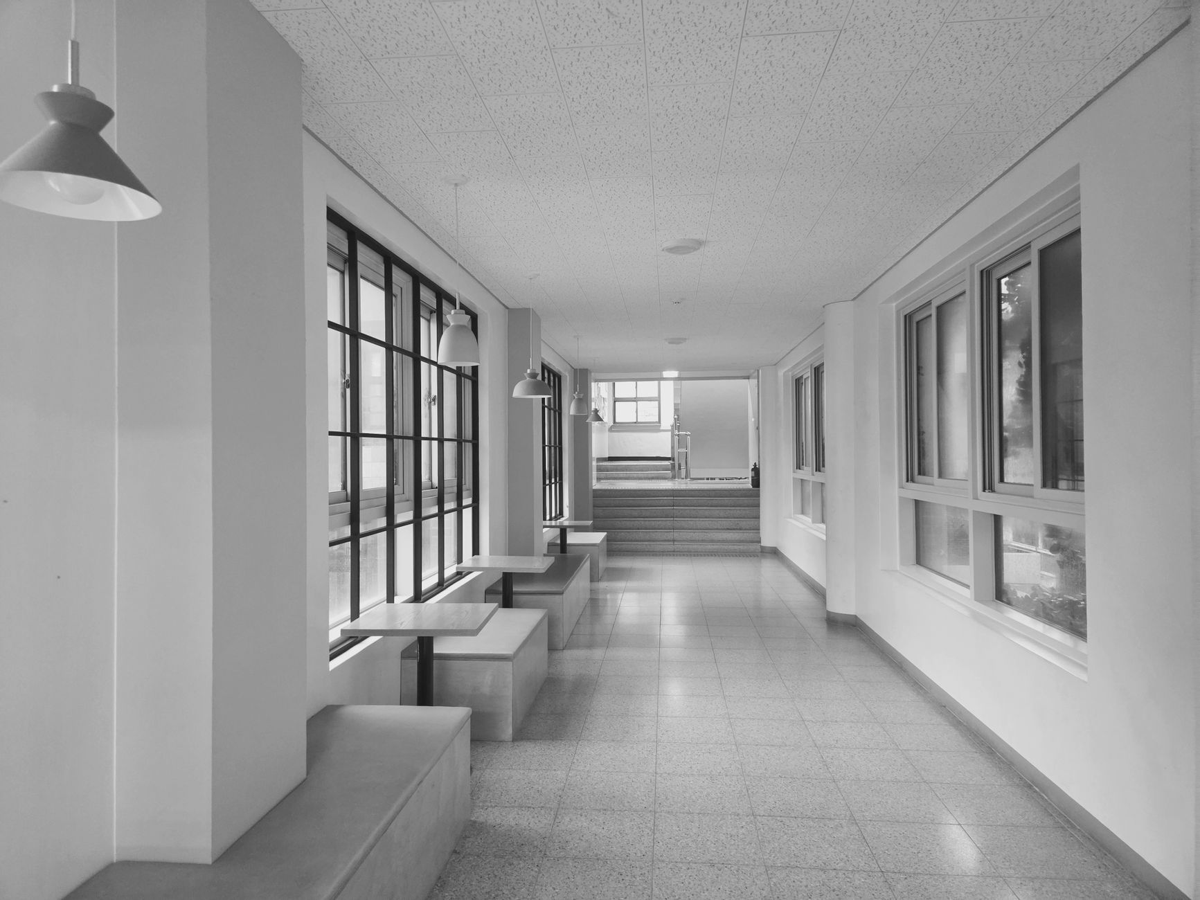 A bright, empty clinical corridor in daylight
